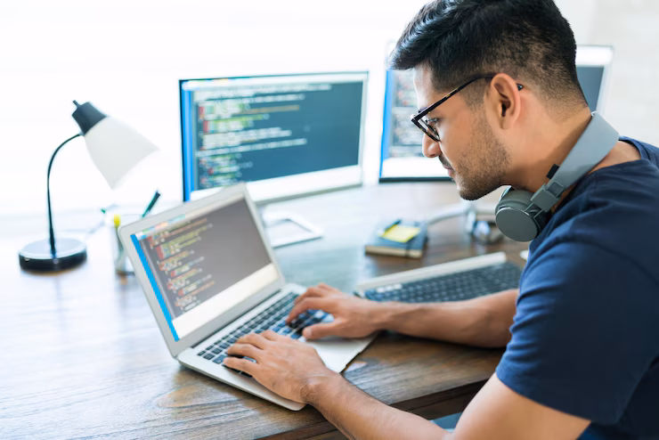 side-view-attractive-hispanic-developer-programming-software-using-computer-while-working-from-home_662251-988